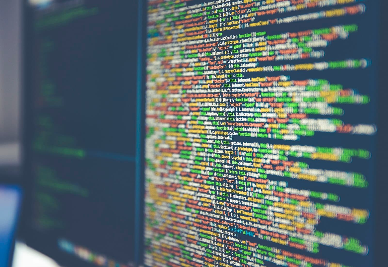 Source code displayed across a developer's monitor